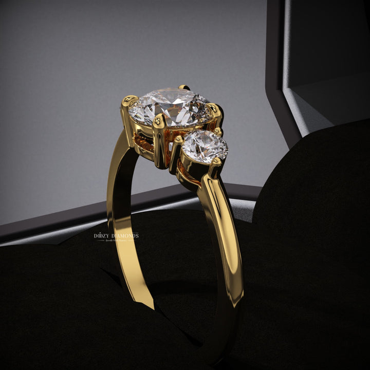 Detailed close-up of round three stone diamond engagement ring