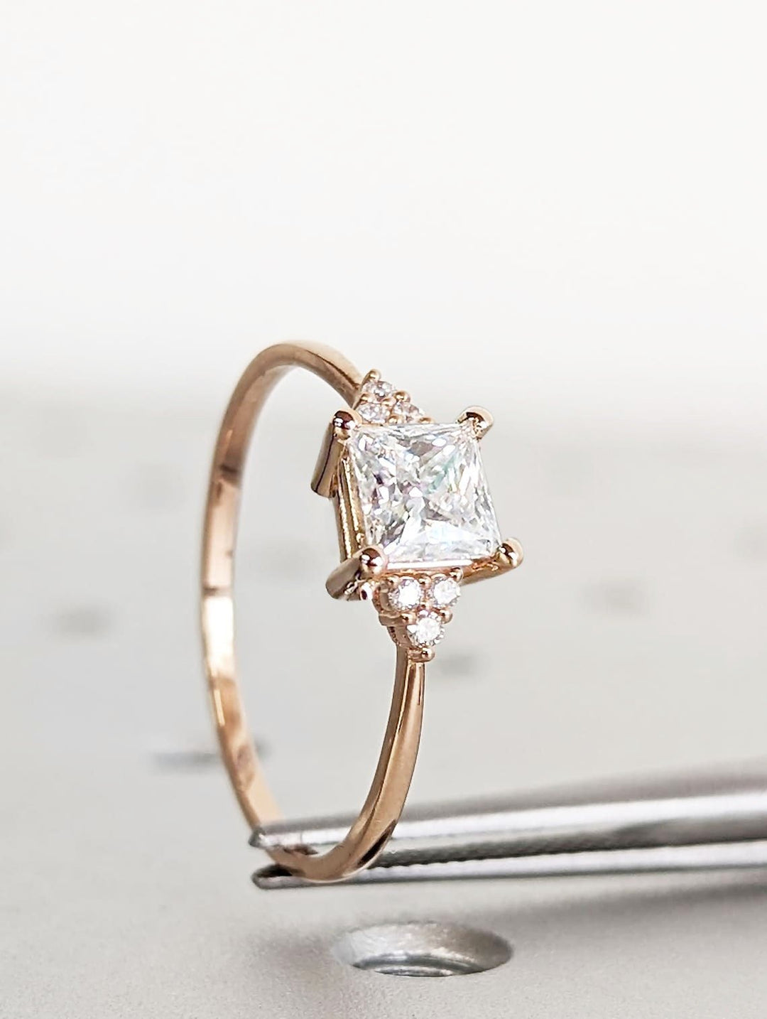 Unboxing view of princess cut cluster diamond engagement ring