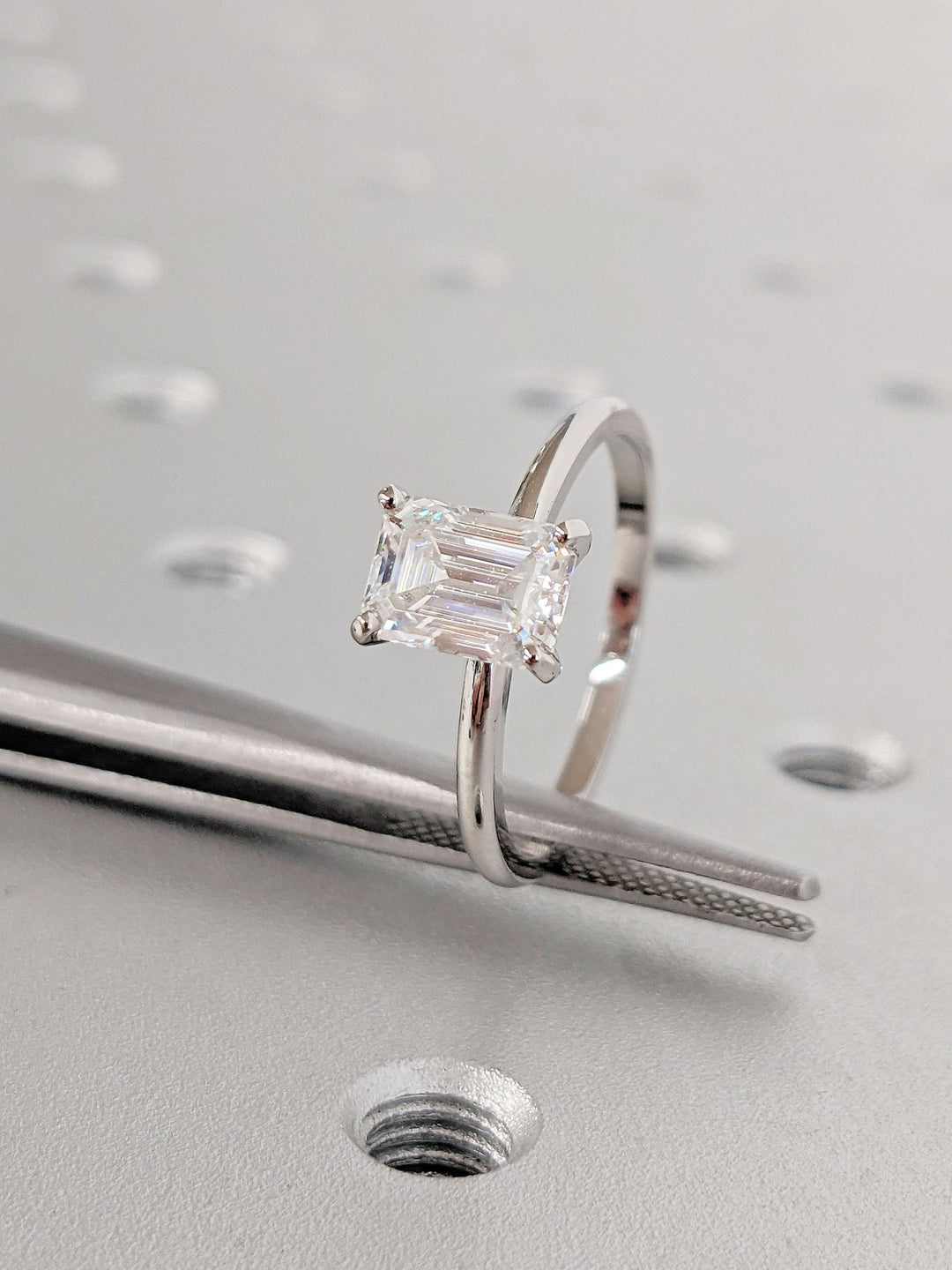 Profile view of emerald cut solitaire engagement ring band