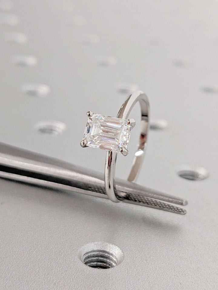 Profile view of emerald cut solitaire engagement ring band
