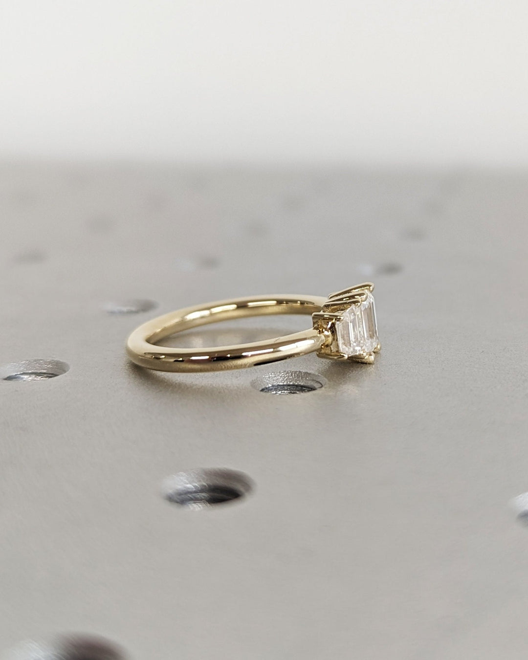 Detailed close-up of emerald solitaire diamond engagement ring