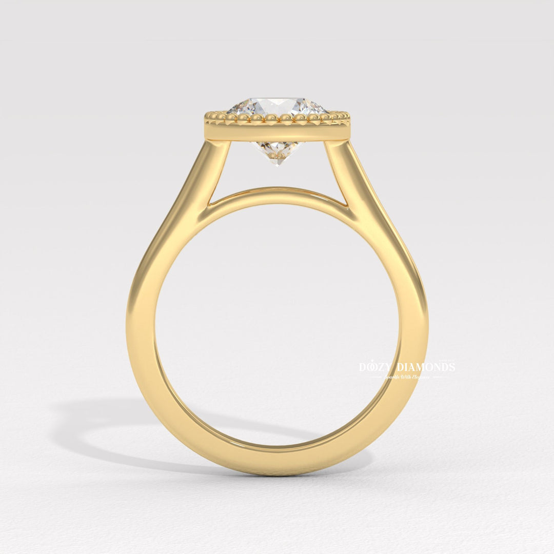 Close-up of round cut center diamond in bezel engagement ring