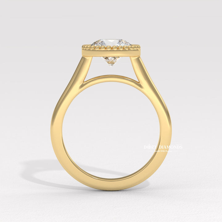 Close-up of round cut center diamond in bezel engagement ring