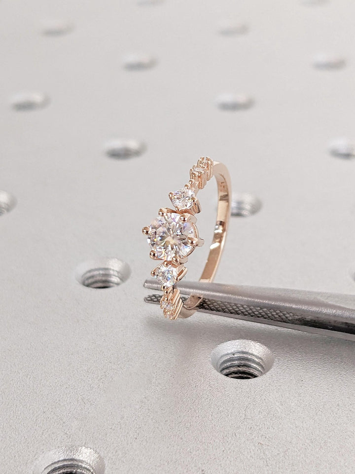 Round cluster diamond ring displayed on jewelry stand