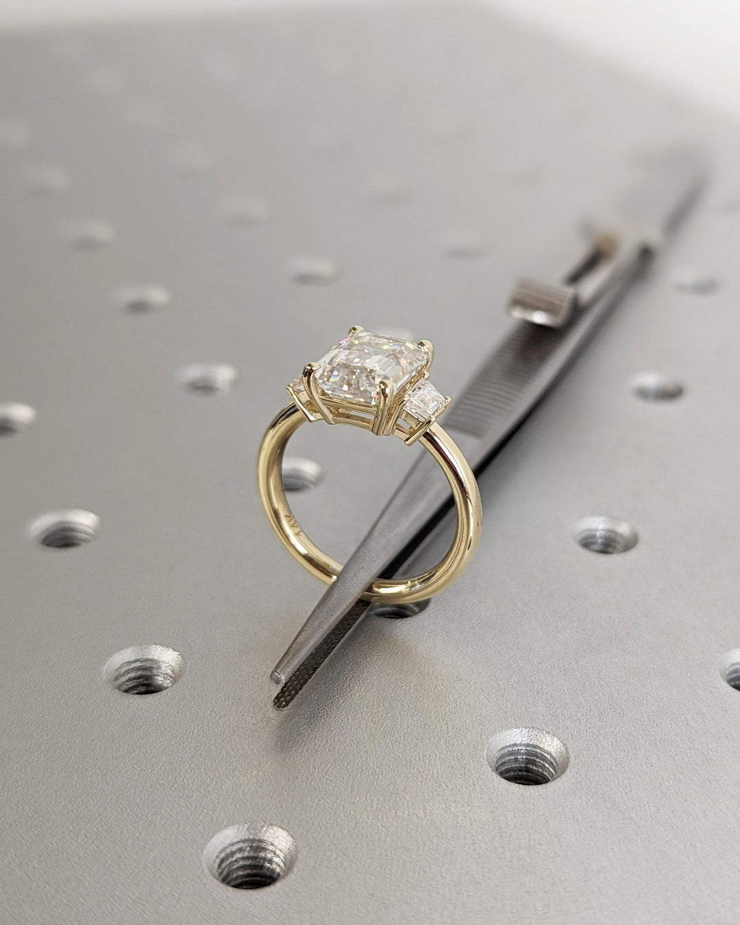 Emerald three stone engagement ring finished in polished solid gold