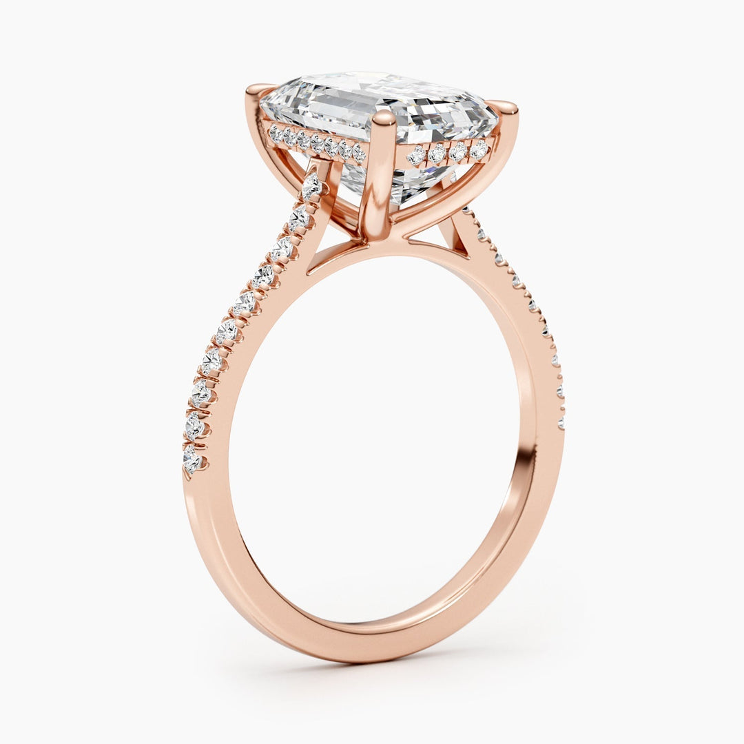 Emerald pave diamond ring displayed on jewelry stand