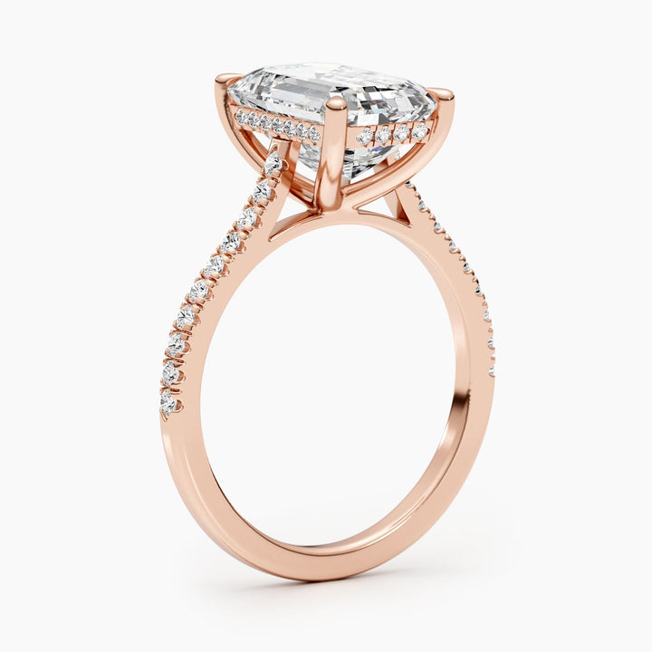 Emerald pave diamond ring displayed on jewelry stand
