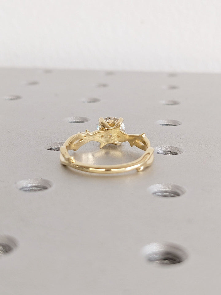 Round cut engagement ring shown with authenticity certificate