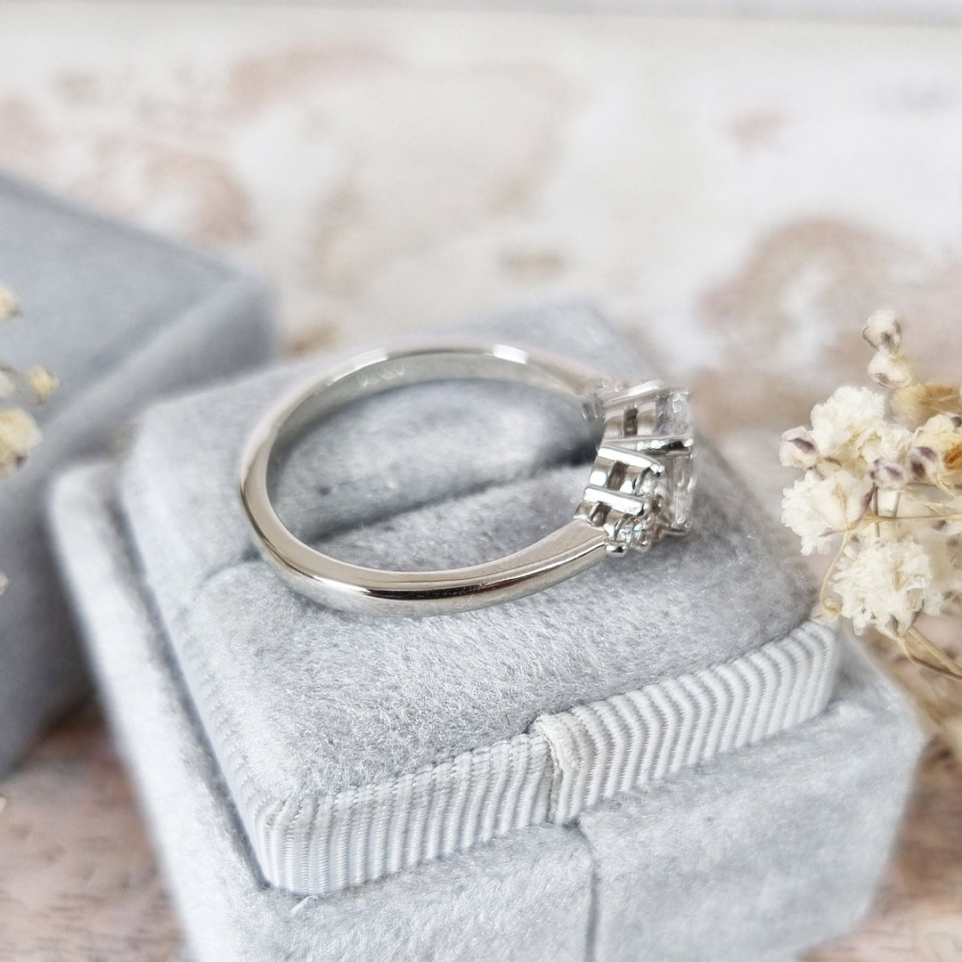 Profile view of oval cut cluster engagement ring band