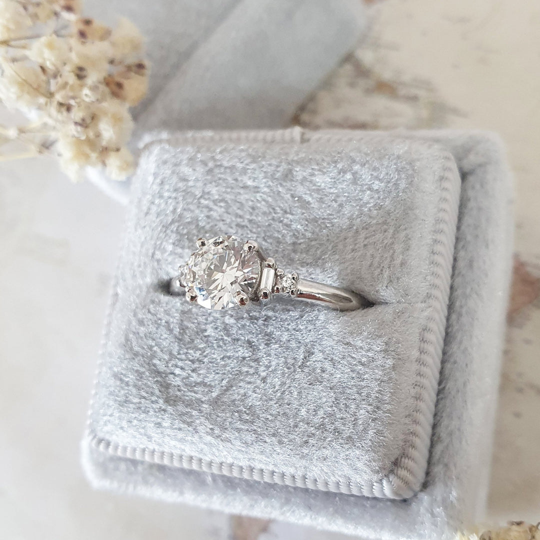 Round five stone engagement ring viewed from the side