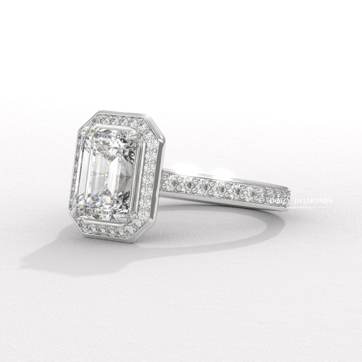Emerald halo engagement ring viewed from the side