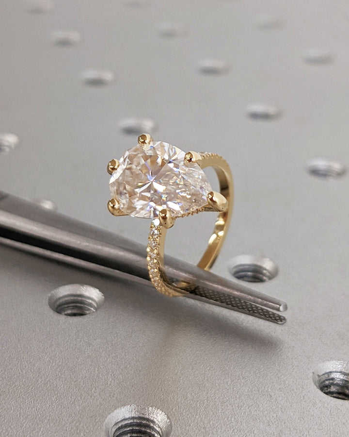 Angled view of pear cut diamond in hidden halo setting