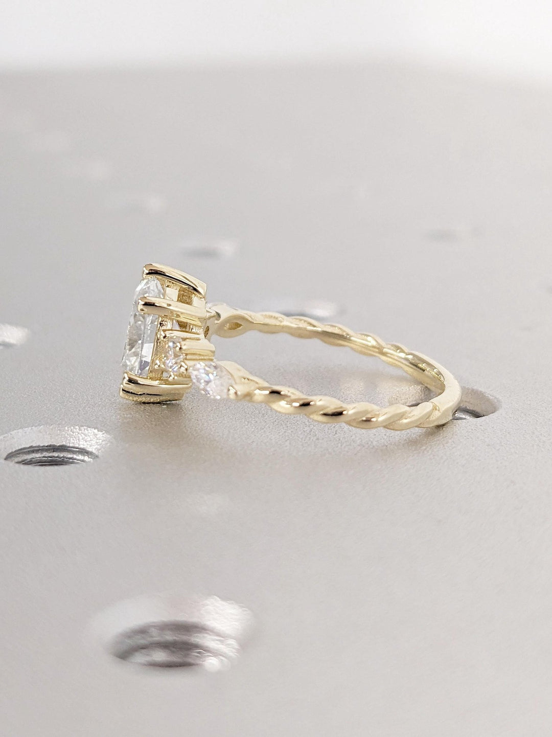 Profile view of oval cut cluster engagement ring band