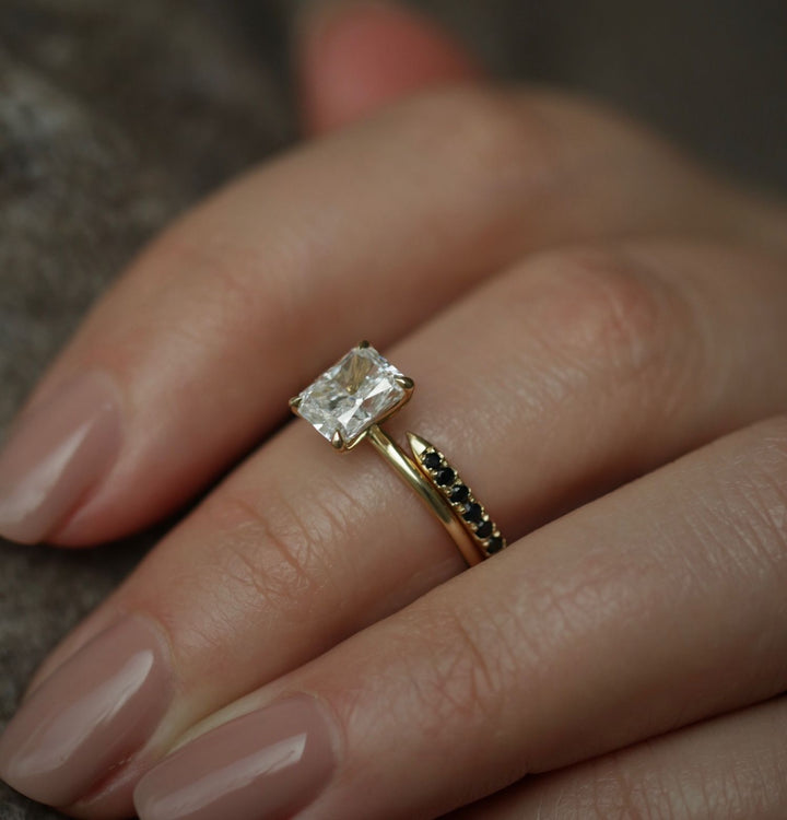 Radiant solitaire engagement ring close-up showing E/VVS2 diamond clarity