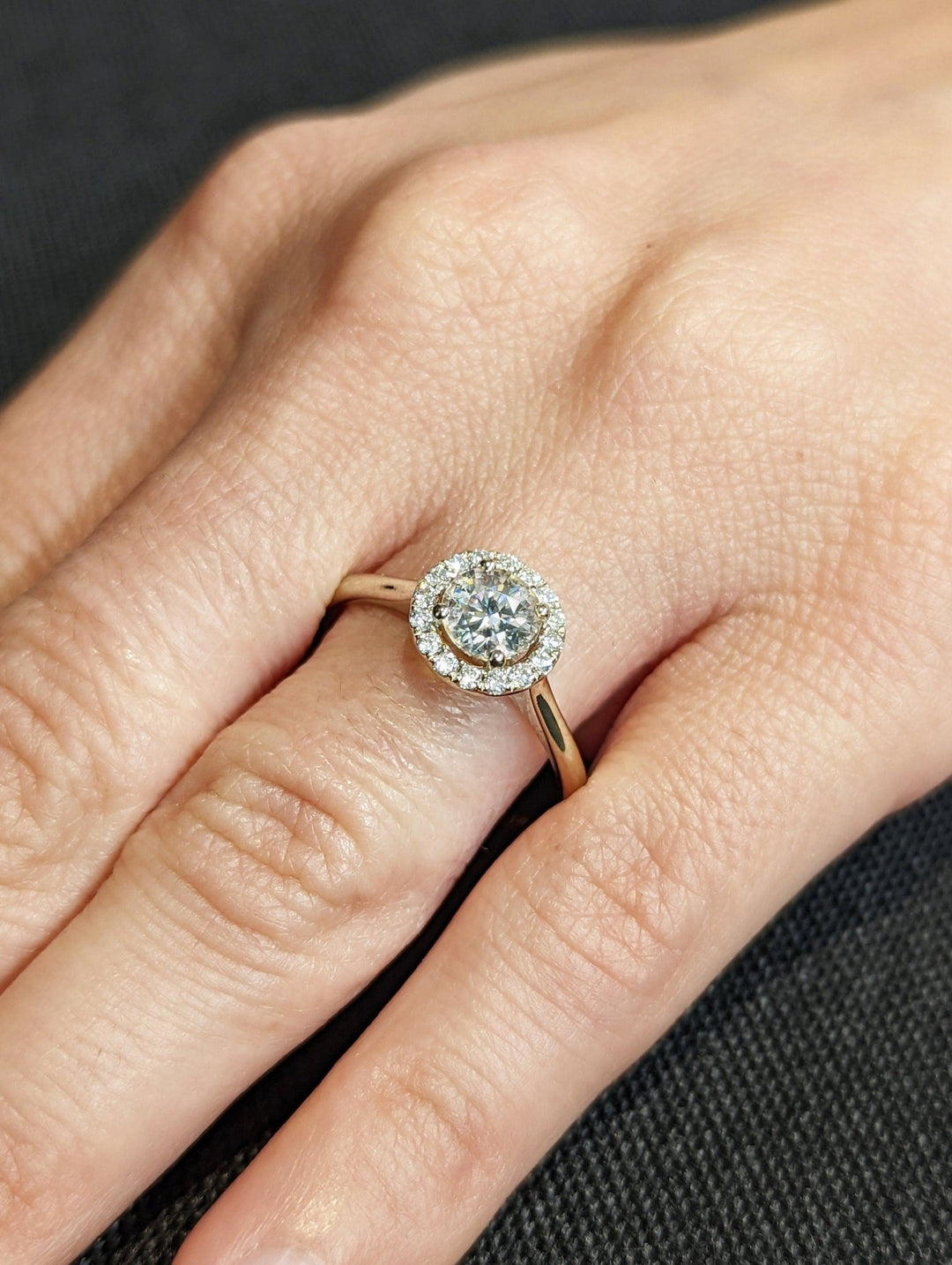 Detailed close-up of round halo diamond engagement ring