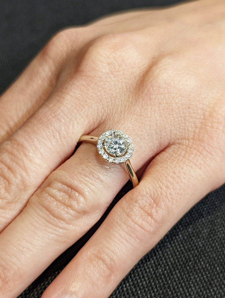 Detailed close-up of round halo diamond engagement ring