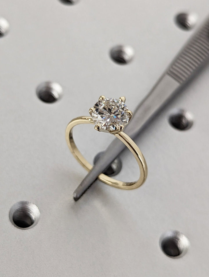 Unboxing view of round cut solitaire diamond engagement ring