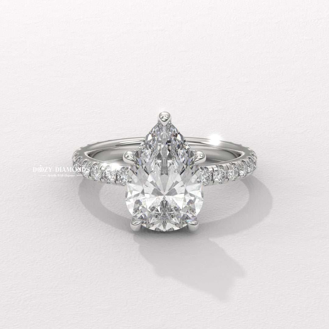 Pear hidden halo diamond ring displayed on jewelry stand