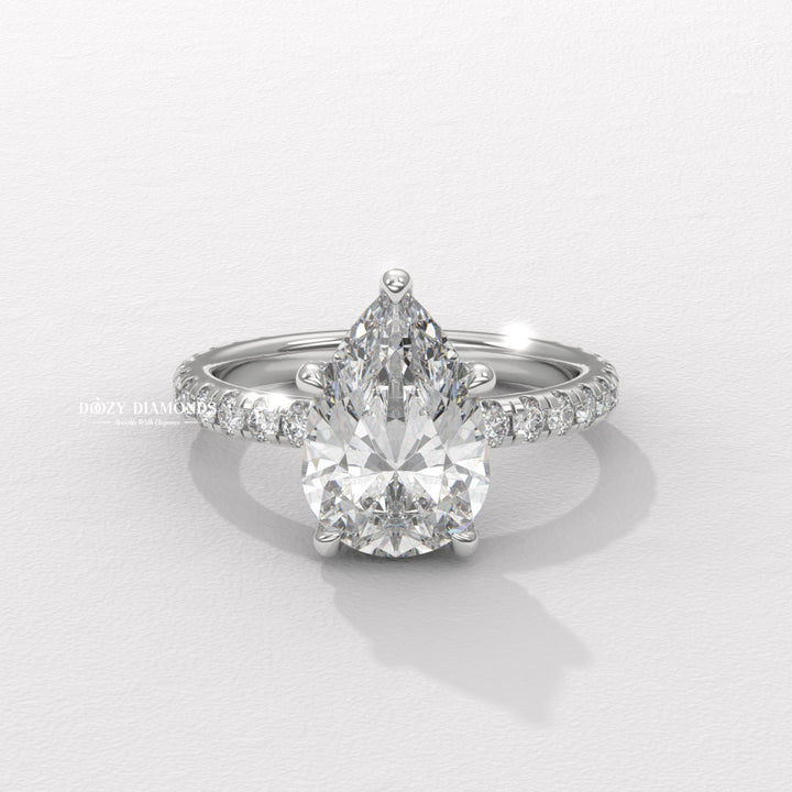 Pear hidden halo diamond ring displayed on jewelry stand