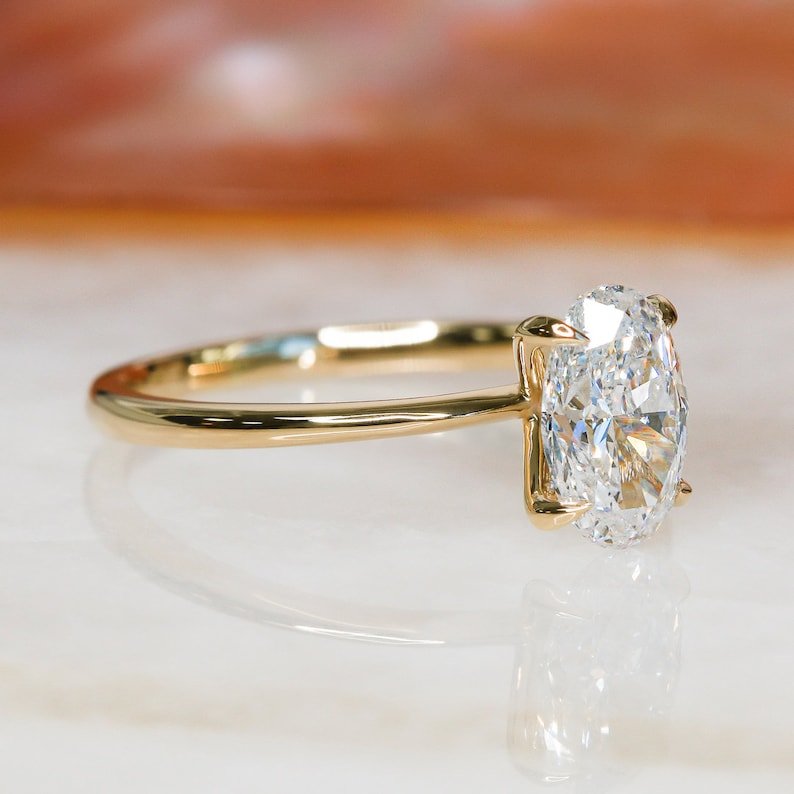 Close-up of oval cut center diamond in solitaire engagement ring