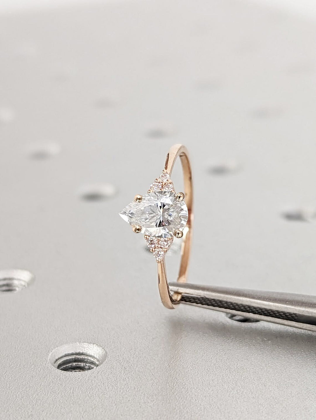Pear cluster engagement ring photographed in natural light