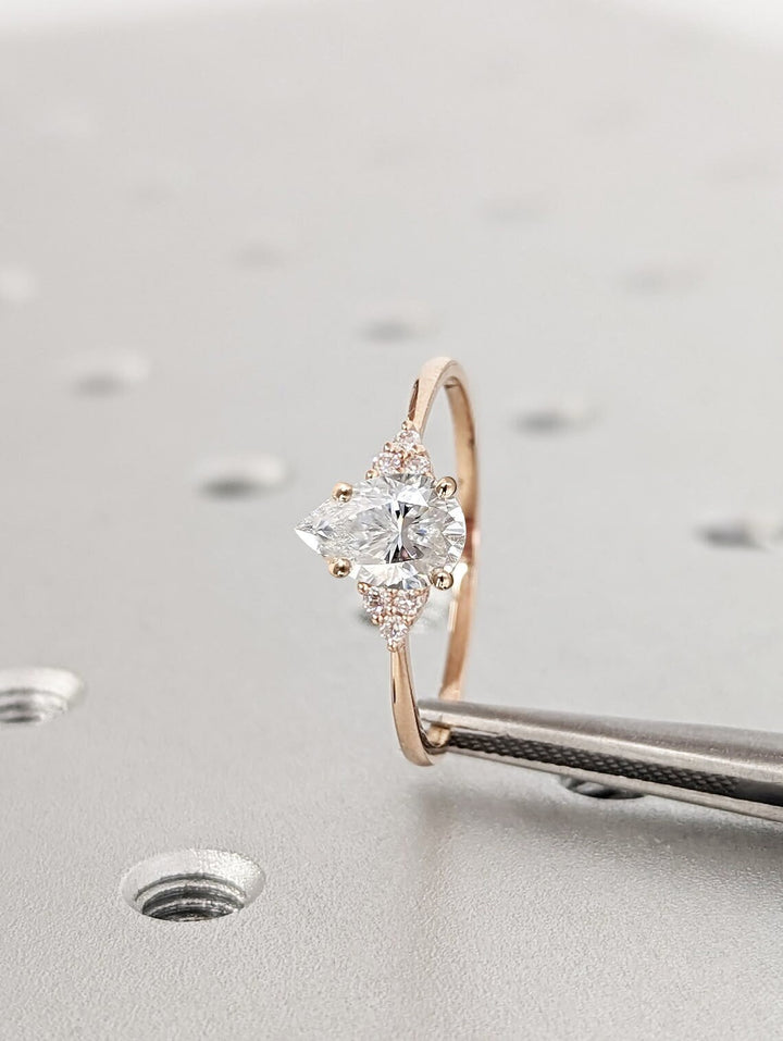 Pear cluster engagement ring photographed in natural light