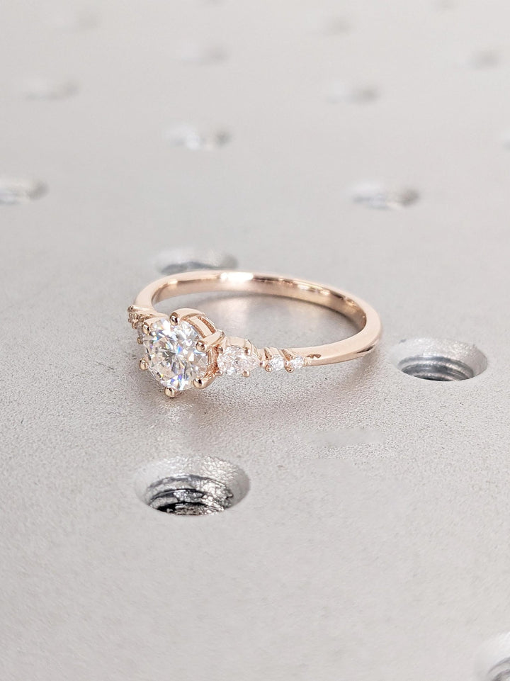 Profile view of round cut cluster engagement ring band