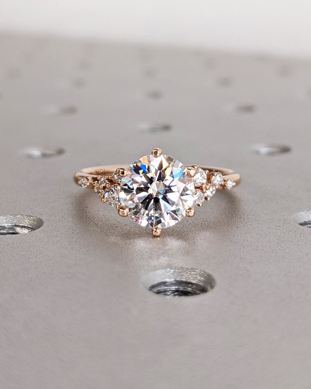 Profile view of round cut cluster engagement ring band