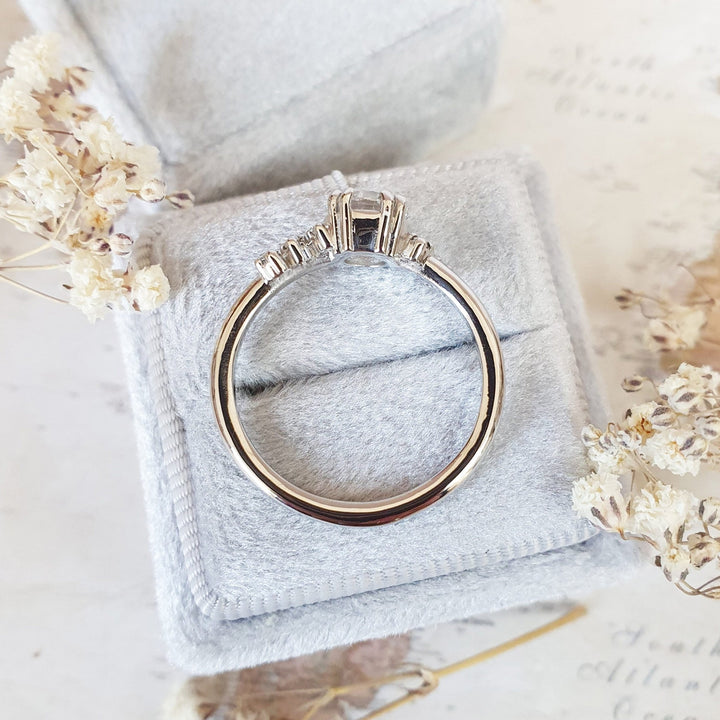 Unboxing view of round cut cluster diamond engagement ring