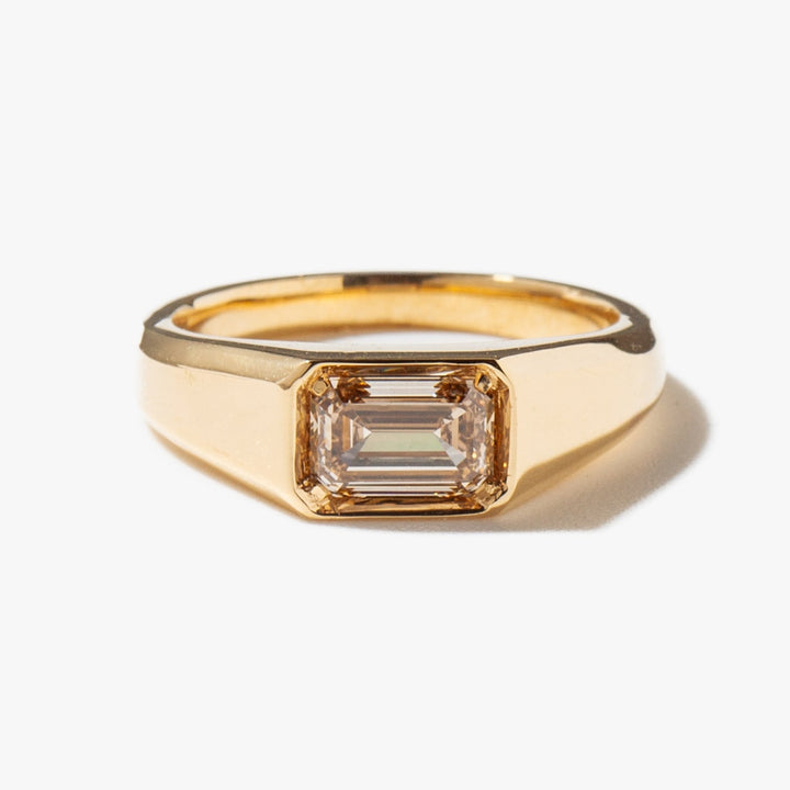 Angled view of emerald cut diamond in solitaire setting
