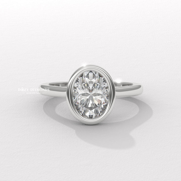 Detailed close-up of oval bezel diamond engagement ring