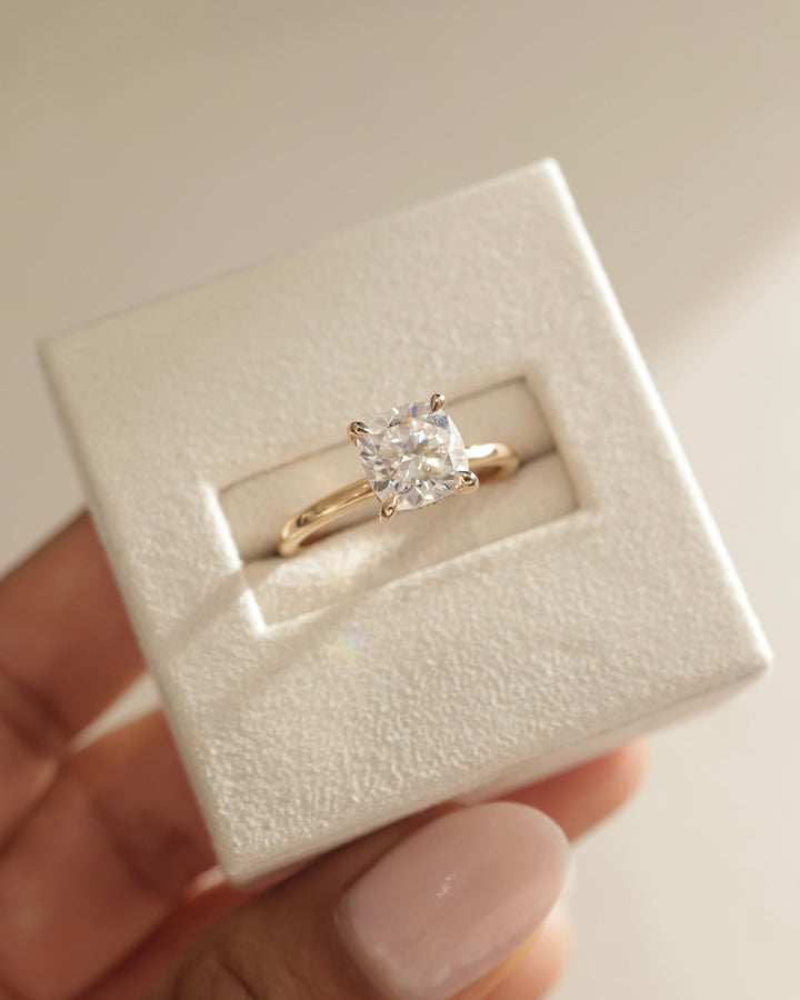 Cushion hidden halo engagement ring close-up showing high clarity diamond clarity