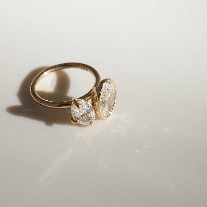 Profile view of oval cut bezel engagement ring band