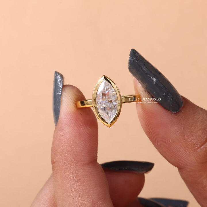 Marquise bezel ring set with an IGI graded diamond