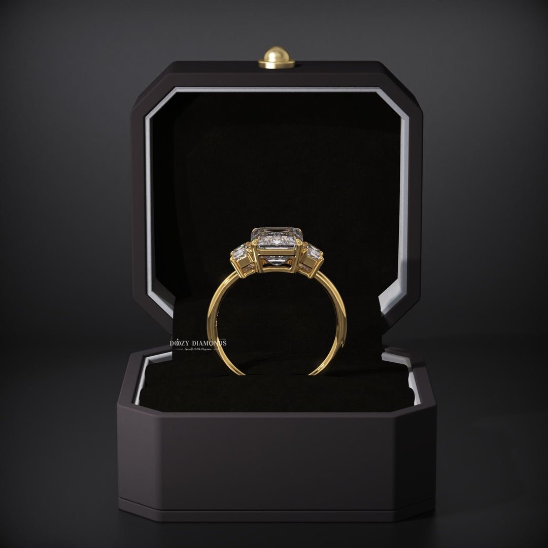 Emerald three stone ring set with an IGI graded diamond