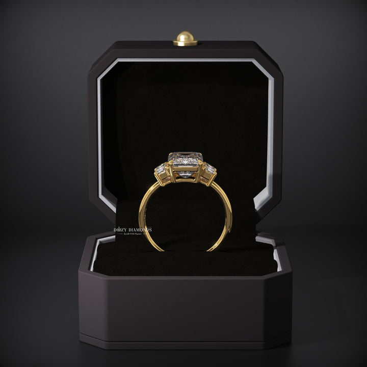 Emerald three stone ring set with an IGI graded diamond