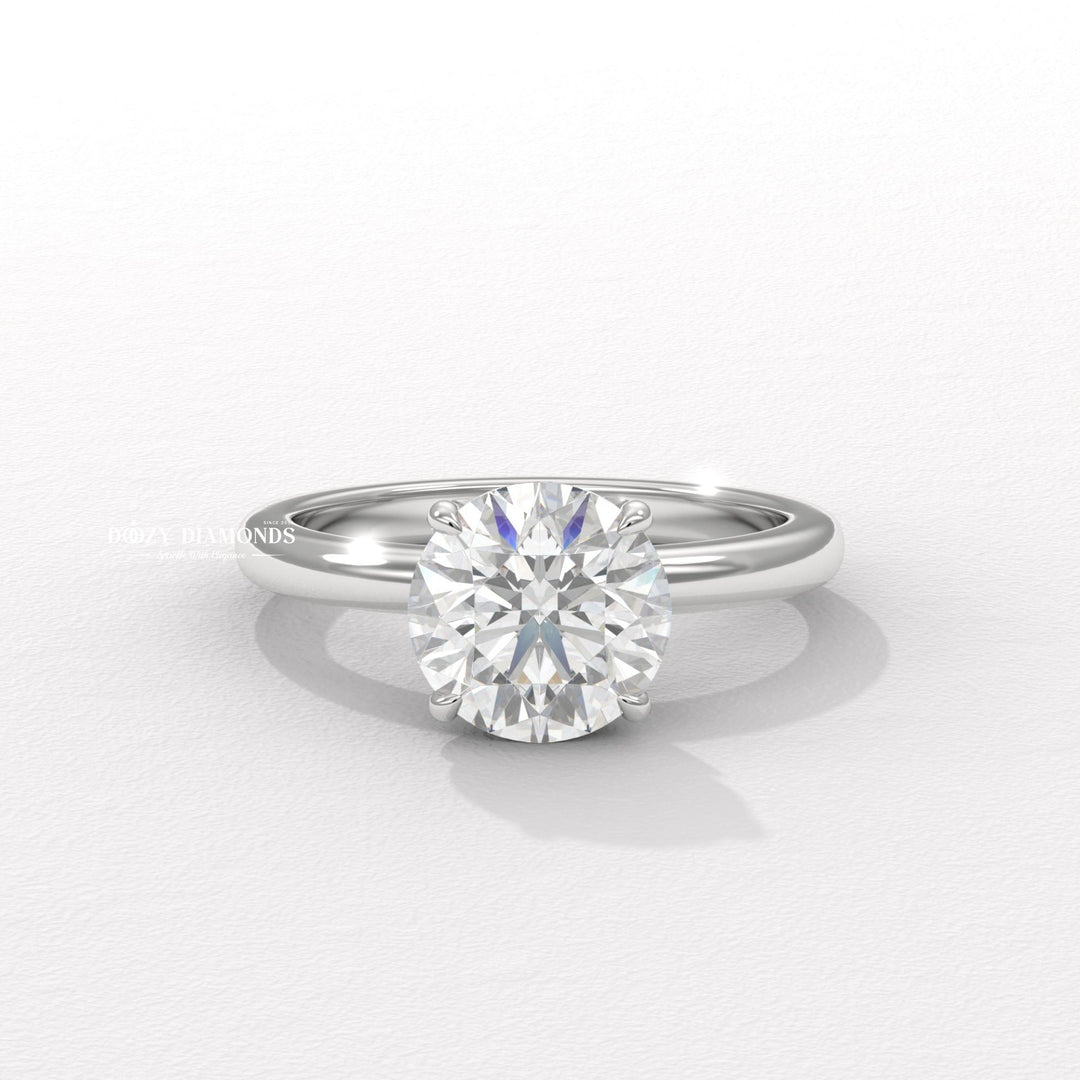 Round solitaire engagement ring shown on hand for true-to-life sizing