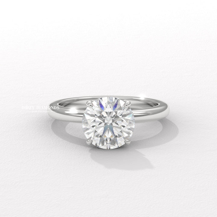 Round solitaire engagement ring shown on hand for true-to-life sizing