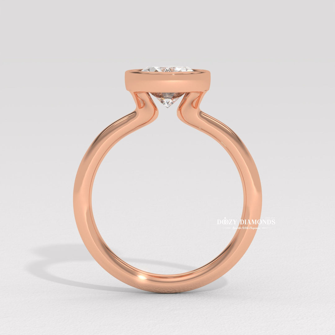 Oval bezel diamond ring displayed on jewelry stand