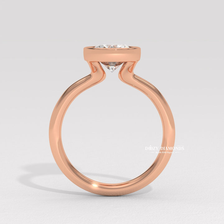 Oval bezel diamond ring displayed on jewelry stand