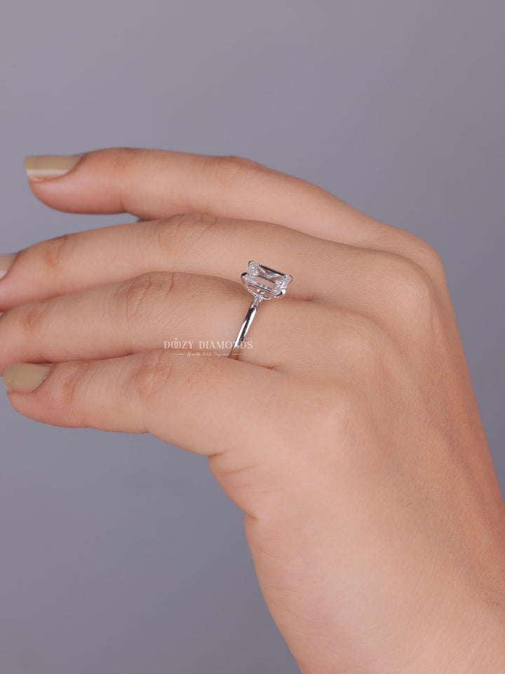 Detailed close-up of emerald solitaire diamond engagement ring