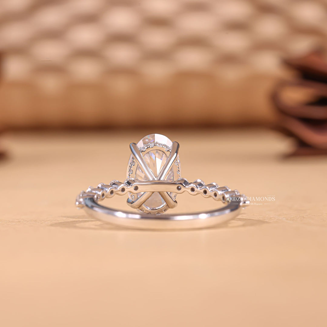Side angle of oval hidden halo diamond engagement ring