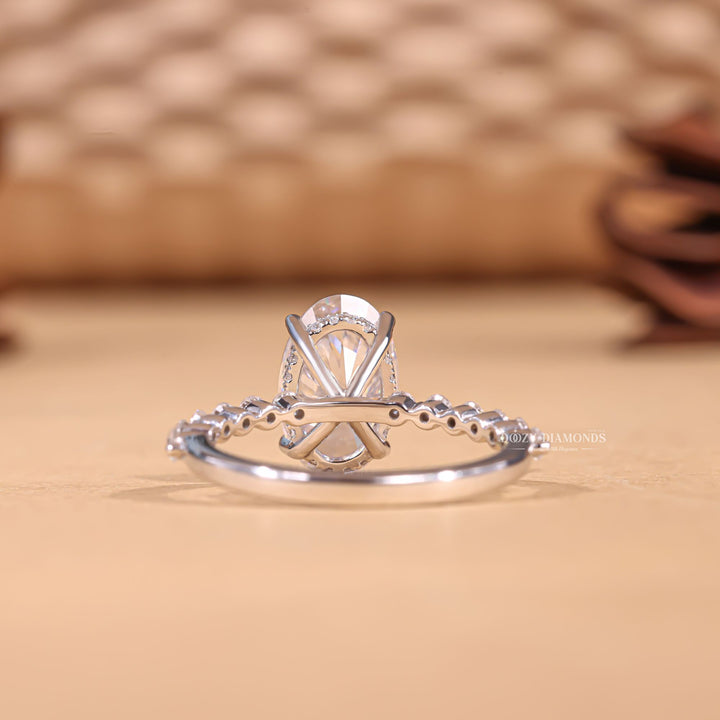 Side angle of oval hidden halo diamond engagement ring