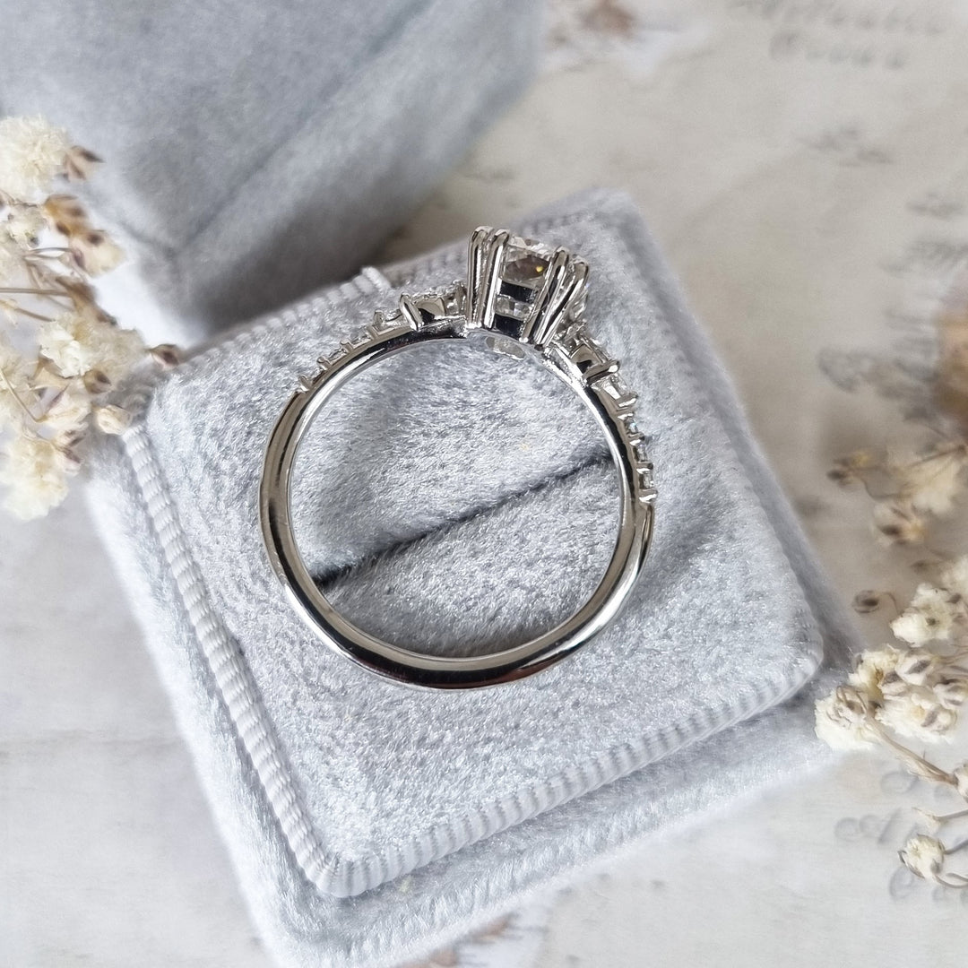 Cushion cluster engagement ring shown on hand for true-to-life sizing