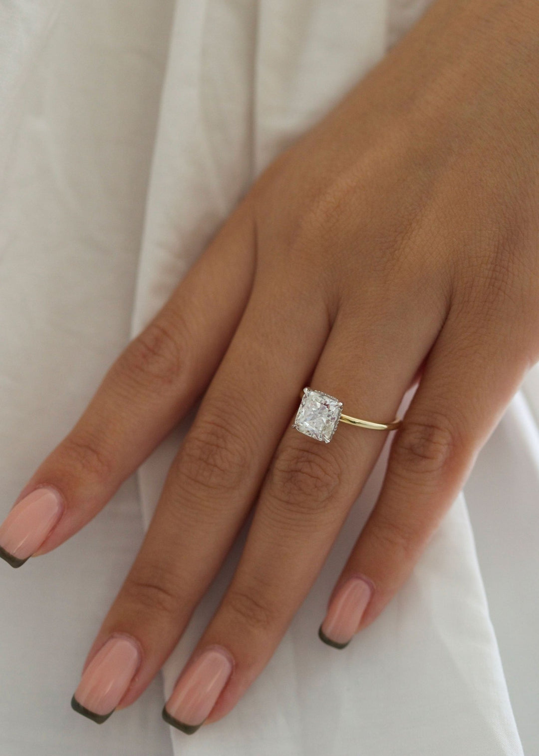 IGI certified cushion cut diamond in hidden halo engagement ring setting
