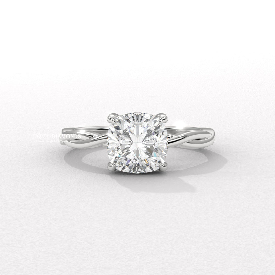 Cushion solitaire engagement ring shown on hand for true-to-life sizing