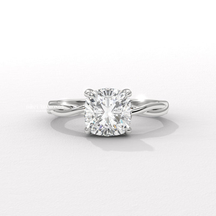 Cushion solitaire engagement ring shown on hand for true-to-life sizing