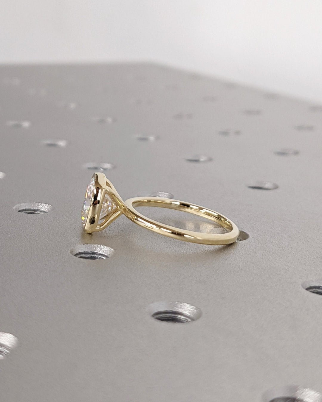 Side angle of cushion bezel diamond engagement ring