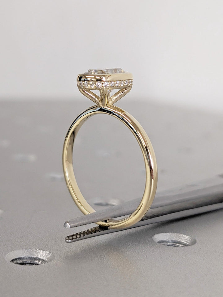 Close-up of cushion cut center diamond in hidden halo engagement ring