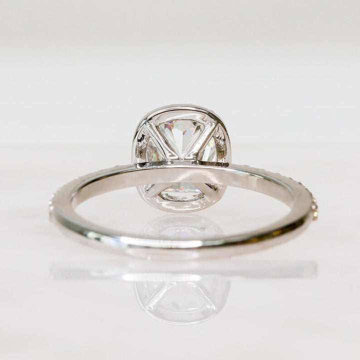 Macro shot of cushion cut diamond facets in halo ring setting
